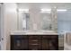 Bathroom with double vanity, dark wood cabinets, white countertop, and a glass enclosed shower at 8314 9Th Avenue Nw Ter, Bradenton, FL 34209