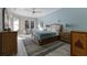 A primary bedroom featuring neutral walls, wood-look floors, a ceiling fan and bedside tables at 8314 9Th Avenue Nw Ter, Bradenton, FL 34209