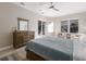 Primary bedroom featuring wood-look flooring, ceiling fan, an ensuite bathroom and a patio access at 8314 9Th Avenue Nw Ter, Bradenton, FL 34209