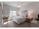 Bright bedroom with a queen-size bed, neutral decor, a ceiling fan, and natural light from the window at 8314 9Th Avenue Nw Ter, Bradenton, FL 34209