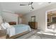 Bright primary bedroom with wood-look tile flooring, ceiling fan, and ensuite bathroom access at 8314 9Th Avenue Nw Ter, Bradenton, FL 34209