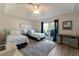 Shared bedroom featuring two twin beds with vaulted ceilings and a natural light from the window at 8314 9Th Avenue Nw Ter, Bradenton, FL 34209