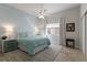 Charming bedroom with a queen-size bed, pale blue walls, wood floors, and a window at 8314 9Th Avenue Nw Ter, Bradenton, FL 34209