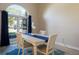 Bright dining area with a white table, light-colored chairs, a blue runner, and large arched window at 8314 9Th Avenue Nw Ter, Bradenton, FL 34209