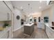Bright kitchen with white cabinets, stainless steel appliances, large island and wood-look tile floor at 8314 9Th Avenue Nw Ter, Bradenton, FL 34209