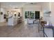 Open-concept living area with wood-look tile flooring, a breakfast bar, and sliding doors to the outdoors at 8314 9Th Avenue Nw Ter, Bradenton, FL 34209