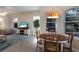 Open-concept living and dining area with a large window view of the pool and backyard at 8314 9Th Avenue Nw Ter, Bradenton, FL 34209