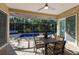 Screened patio area with table and chairs for outdoor dining, adjacent to a sparkling private pool at 8314 9Th Avenue Nw Ter, Bradenton, FL 34209