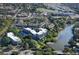 High angle scenic aerial view of community condos and a pool with lush landscaping near the river at 835 S Osprey Ave # 310, Sarasota, FL 34236