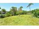 Lush green lawn in the backyard with a bridge in the background offering scenic views at 835 S Osprey Ave # 310, Sarasota, FL 34236