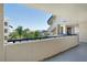 View from the balcony showing the exterior of the condo and tropical landscaping at 835 S Osprey Ave # 310, Sarasota, FL 34236