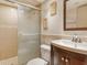 A cozy bathroom featuring a tiled shower with a glass door, a modern toilet, and a stylish sink with vanity at 835 S Osprey Ave # 310, Sarasota, FL 34236