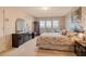 Spacious bedroom featuring a large dresser, access to a balcony, and comfortable furnishings at 835 S Osprey Ave # 310, Sarasota, FL 34236