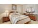 A well-decorated bedroom features a bed with decorative pillows, a nightstand, and a dresser with a large mirror at 835 S Osprey Ave # 310, Sarasota, FL 34236