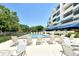 Inviting community pool surrounded by lounge chairs and blue awnings, ideal for relaxation at 835 S Osprey Ave # 310, Sarasota, FL 34236
