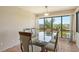 Bright dining room featuring a glass-top table and scenic water views through large windows at 835 S Osprey Ave # 310, Sarasota, FL 34236