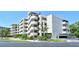 Low angle view of a condo building featuring well-kept landscaping and a unique circular stairway design at 835 S Osprey Ave # 310, Sarasota, FL 34236