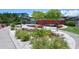 Community center with a unique red brick facade, surrounded by beautiful landscaping and greenery at 835 S Osprey Ave # 310, Sarasota, FL 34236