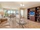 Open-concept living and dining area featuring tile flooring and expansive windows at 835 S Osprey Ave # 310, Sarasota, FL 34236