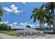 Welcoming entrance to Payne Park with palm trees under a blue sky with fluffy white clouds at 835 S Osprey Ave # 310, Sarasota, FL 34236