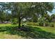 A shaded picnic area featuring a wooden table and seating on a grassy lawn near the park at 835 S Osprey Ave # 310, Sarasota, FL 34236