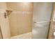 An accessible shower with tiled walls, a built-in shelf, and a glass door offers a spa-like experience at 835 S Osprey Ave # 310, Sarasota, FL 34236