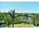 Scenic water view through the lanai screen, showcasing lush landscaping and a serene waterfront setting at 835 S Osprey Ave # 310, Sarasota, FL 34236