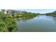 Scenic water view showcasing tranquil water, lush trees, and the building exterior in the distance at 835 S Osprey Ave # 310, Sarasota, FL 34236