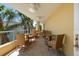 Spacious balcony with outdoor seating, tropical landscaping, and peaceful atmosphere at 915 Seaside Dr # 405 Weeks 22-23, Sarasota, FL 34242
