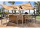 Outdoor bar area with an umbrella and seating at 915 Seaside Dr # 405 Weeks 22-23, Sarasota, FL 34242