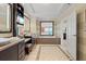 Beautiful bathroom featuring double vanity, large soaking tub, and tiled flooring at 915 Seaside Dr # 405 Weeks 22-23, Sarasota, FL 34242