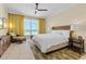 Bedroom with ocean views, seating area, ceiling fan and neutral color palette at 915 Seaside Dr # 405 Weeks 22-23, Sarasota, FL 34242