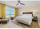 Bedroom featuring natural light, ceiling fan, and ocean view from the expansive windows at 915 Seaside Dr # 405 Weeks 22-23, Sarasota, FL 34242
