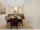 Dining room with round table, chandelier, and decorative mirror with tile flooring at 915 Seaside Dr # 405 Weeks 22-23, Sarasota, FL 34242