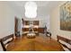 Open dining room with custom light fixture and view to kitchen and ocean at 915 Seaside Dr # 405 Weeks 22-23, Sarasota, FL 34242