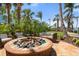 Outdoor fire pit with seating and tropical landscaping at 915 Seaside Dr # 405 Weeks 22-23, Sarasota, FL 34242