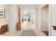 Hallway with light tile, detailed tile accent, decorative sticks and view to the ocean at 915 Seaside Dr # 405 Weeks 22-23, Sarasota, FL 34242