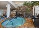 Indoor hot tub with a waterfall feature and stone wall accents at 915 Seaside Dr # 405 Weeks 22-23, Sarasota, FL 34242