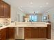 Open kitchen with custom cabinets, stainless steel appliances and partial view of ocean at 915 Seaside Dr # 405 Weeks 22-23, Sarasota, FL 34242