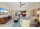 Bright living room with tile floors featuring a large TV and modern furniture at 915 Seaside Dr # 405 Weeks 22-23, Sarasota, FL 34242