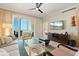 Bright living room featuring a ceiling fan, tile floor, and sliding glass doors to the balcony at 915 Seaside Dr # 405 Weeks 22-23, Sarasota, FL 34242