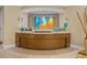 Modern reception desk with glass displays, artistic lighting, and soothing color palette at 915 Seaside Dr # 405 Weeks 22-23, Sarasota, FL 34242