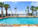 Community pool with a beach in the background at 915 Seaside Dr # 405 Weeks 22-23, Sarasota, FL 34242