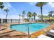 Bright community pool with a beach view and palm trees at 915 Seaside Dr # 405 Weeks 22-23, Sarasota, FL 34242