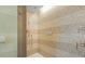 Modern shower features tiled walls with integrated shelving and glass doors at 915 Seaside Dr # 405 Weeks 22-23, Sarasota, FL 34242
