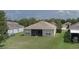 Aerial view of a home's backyard with lush green lawn and screened-in patio at 11319 82Nd E St, Parrish, FL 34219