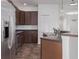 Well-lit kitchen featuring stainless steel appliances, dark wood cabinets, and a breakfast bar at 11319 82Nd E St, Parrish, FL 34219