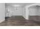 Expansive living area featuring stylish wood-look floors, highlighted by a modern chandelier and an open layout at 11319 82Nd E St, Parrish, FL 34219