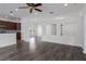 Open living area with wood-look floors, showcasing seamless transitions to the kitchen and other living spaces at 11319 82Nd E St, Parrish, FL 34219