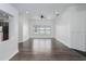 Spacious living room with wood-look floors, complemented by recessed lighting and a large window for natural light at 11319 82Nd E St, Parrish, FL 34219